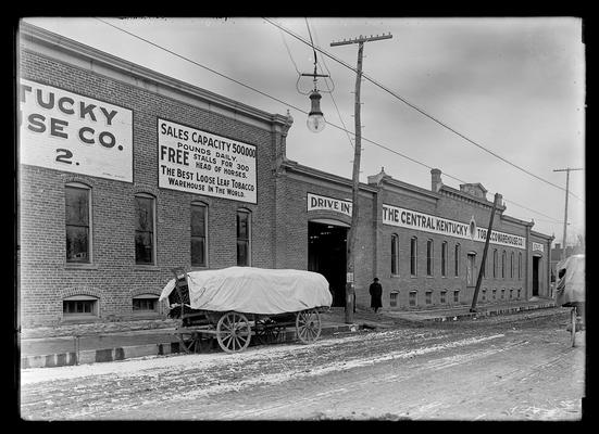 Central Kentucky Warehouse with loaded tobacco wagon outside, across from University of Kentucky campus on South Lime