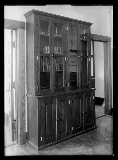 Chemical cabinet, glass doors at top, wooden doors at bottom