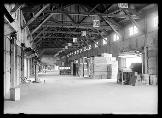 Interior of freight depot, overhead numbers 108 through 126