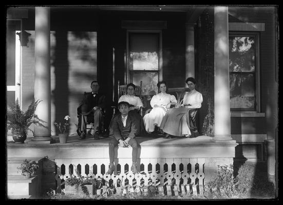 Group, possibly a family, sitting on the porch together