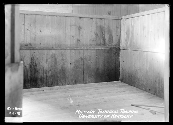 Bare room, wooden walls and floor, notation Bath room