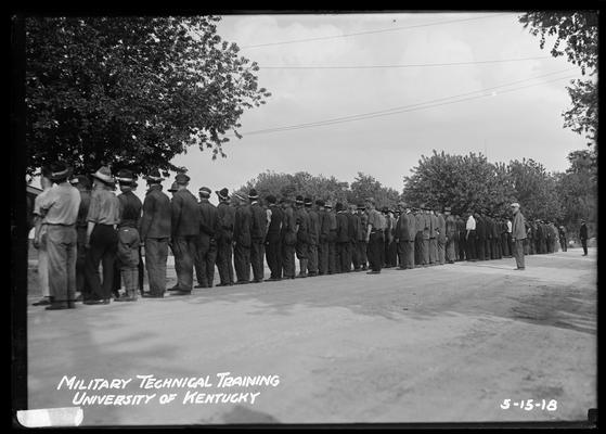 Rear view of group of men along road