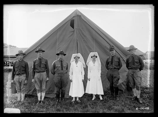 Five men, two nurses outside tent, notation medical detachment as given in Looking Forward