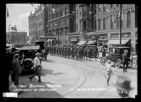 Rear view of men marching from South Limestone on Main to Union Station, Phoenix hotel, Western Union, etc