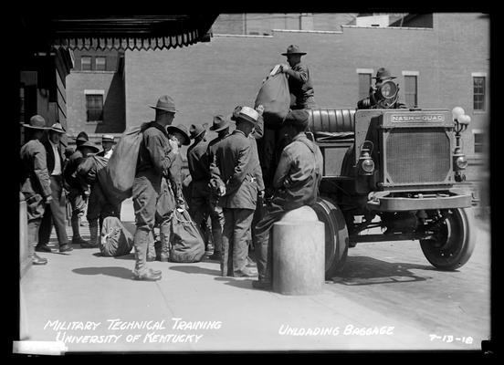 Men claiming baggage in front of Union Station, notation Unloading baggage