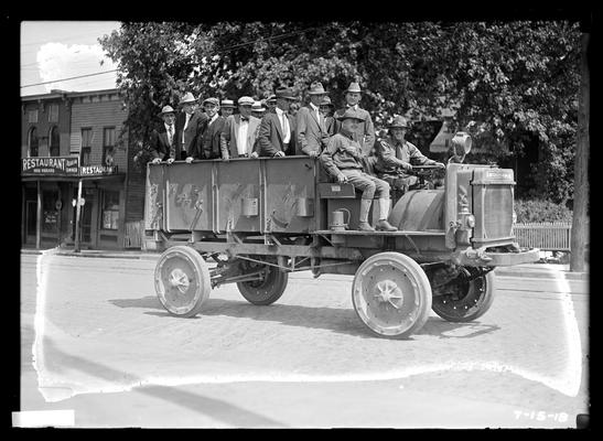 Truck filled with men, note sign, restaurant, Miss Hubbard, notation Riding to new home