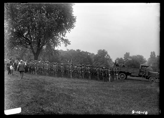 Farewell address, men standing under tree, speaker in back of truck, view from side