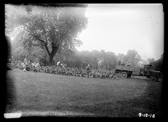 Farewell address, men seated, few women at back, horse and buggy in background