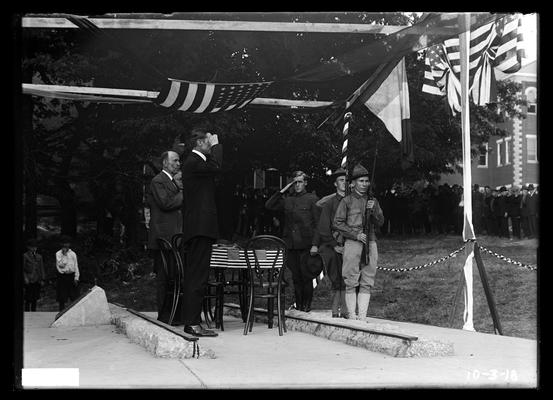 Men in flag-draped tent over Railroad Memorial, notation Naturalization ceremonies