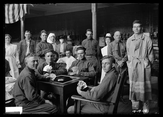 Recuperating (from flu?), playing cards, nurses, in old gym
