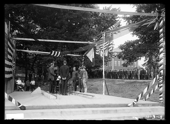 Naturalization, men at Railroad Memorial, others standing outside Miller Hall in background