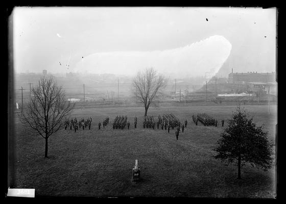 Cadet band to left, other units to right, cannon in background, South Broadway in distance