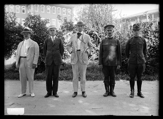 Five men with hats on, two military: Dean F. Paul Anderson, D. Howard Peak, President Frank L. McVey, Commandant H.N. Royden, Captain Harding