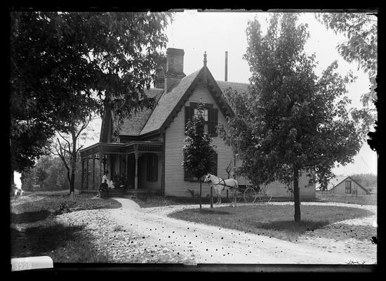 Commandant's house, Captain Swigert's house, captain, two women, another man seated on porch, horse hitched to buggy