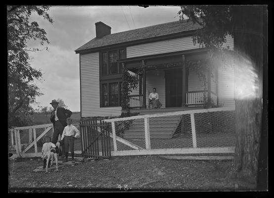 Scott Farm house, man, two children and dog, woman on porch
