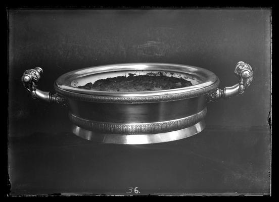 Silver bowl containing poisoned salmon, see Dr. Peter's files for newspaper clipping concerning this