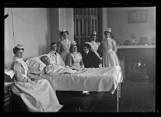 Hospital patient, two men and five nurses