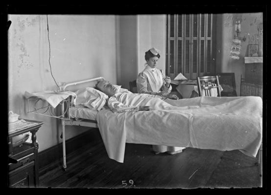 Nurse taking a patient's temperature