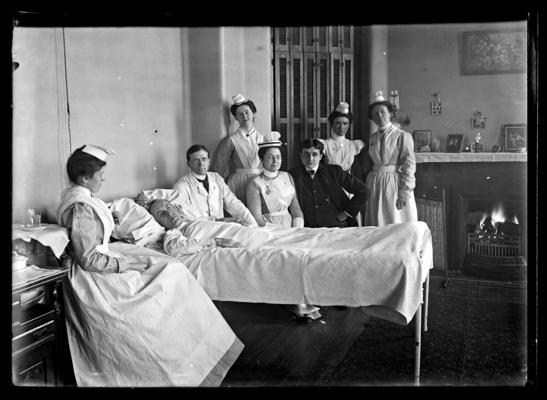 Hospital patient, two men and five nurses