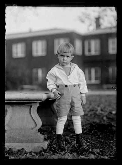 Boy by stone bench