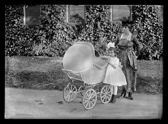 Woman, girl and baby buggy