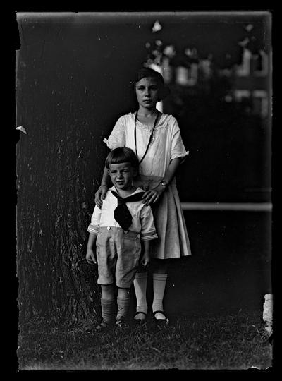 Girl and one boy standing