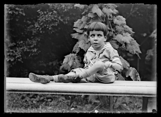 Young boy on stone bench