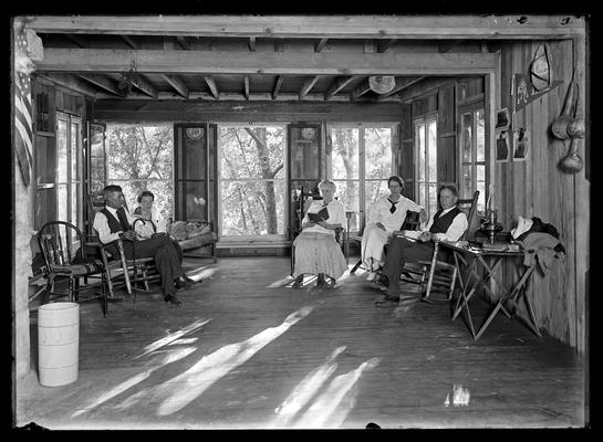 Roger Smith's camp, interior with two men and three women