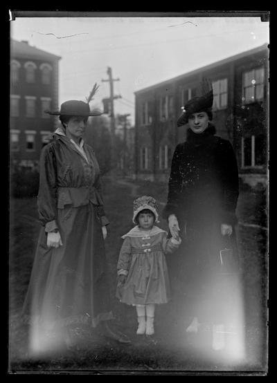 Two women and girl on campus