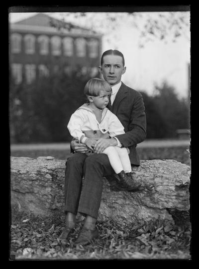 Man with boy, Miller Hall in background