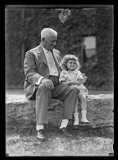 Man with girl, in front of Mechanical Hall