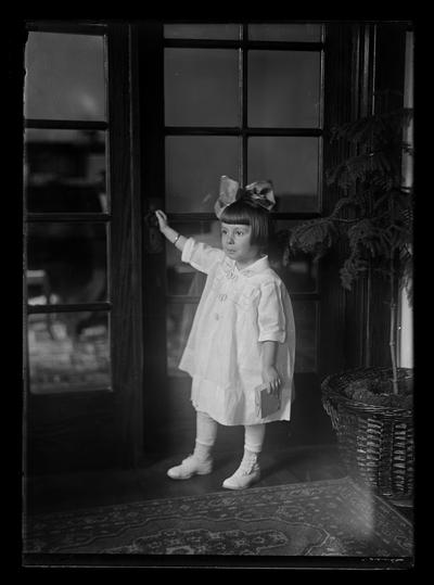 Girl with big bow at door