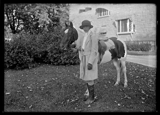 Girl standing by horse in habit, Berryman neg