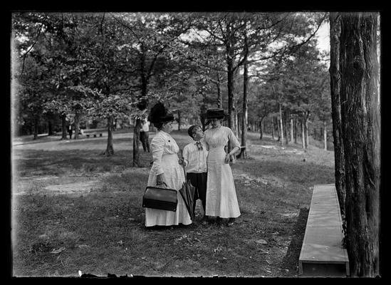 Two women and boy in woodland