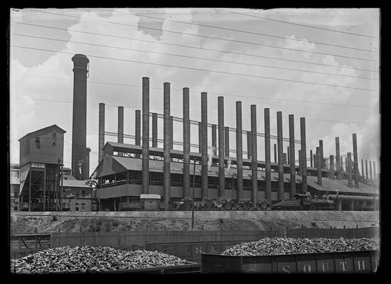 Industrial plant with coal cars in foreground