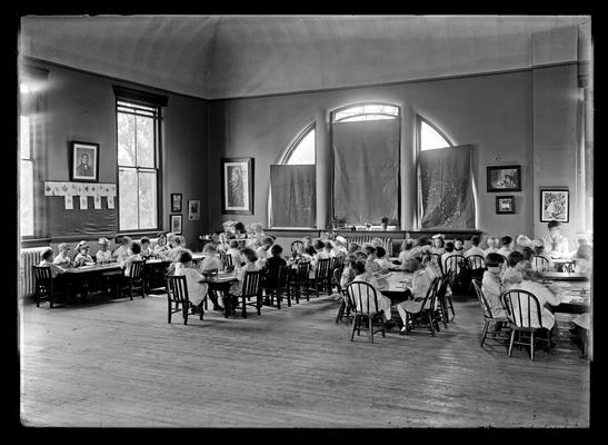 School, elementary group in class room, leaf prints on wall