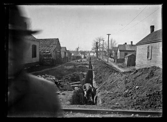 Lexington, City Engineers Office, man placing sewer pipes