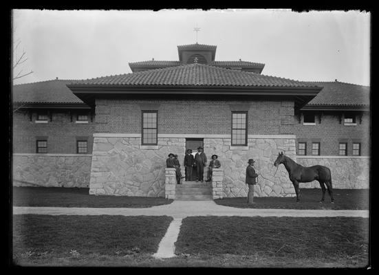 J.B. Haggin's stable, rear, with horse and people