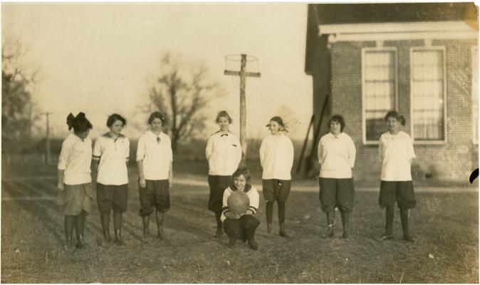 Group portrait of Athens' girls basketball team. Mable Gentry Doolin is holding the basketball. Handwritten on verso Athen's Basket Ball Team. Mable Gentry Doolin-with basketball
