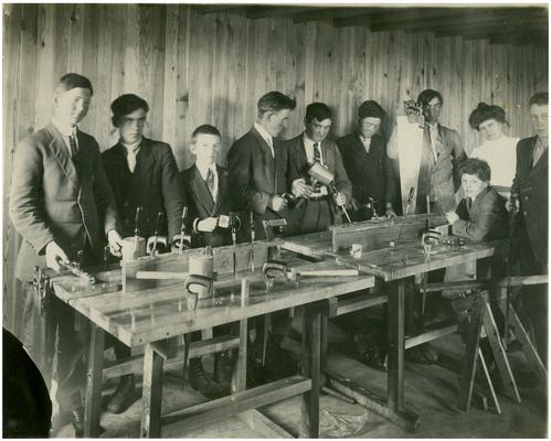 Athens' boys in industrial arts class with Nannie Faulconer (1865?-1940). Handwritten on verso Athens Manual training class. Supt. Nannie Faulconer (left). Date (19 teenth, after 12 when school completed)