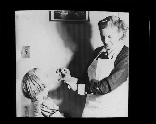 A student receives a throat examination