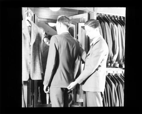 Student working in suit store