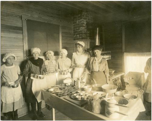 Locust Grove students, Nannie Faulconer (1865-1940), and Grace Yochum in the newly built school kitchen. Handwriting on verso (Four copies)