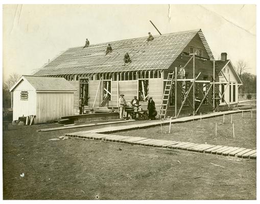 Nannie Faulconer (1865?-1940) and carpenters during the construction of the new Maddoxtown school house. Handwritten on verso, Community workers making an addition to Maddoxtown Colored School
