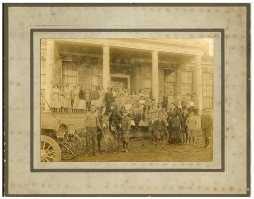 Group portrait of Picadome students on the steps with Nannie Faulconer (1865?-1940) on the donkey