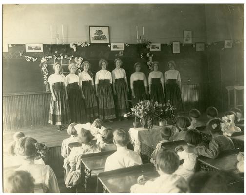 Picadome girls stand before class on Presentation Day. Handwritten on verso, Picadome Class Day
