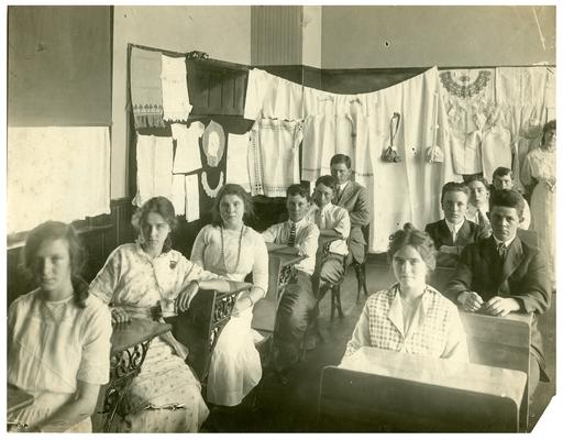 Picadome students seated at desks in sewing class (view from front right of room). Handwritten on verso, Another Picadome sewing class