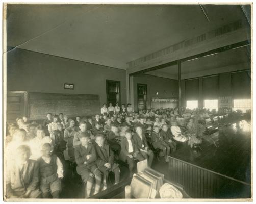 Picadome students seated at desks (view from front left of the room). Handwritten on verso, Picadome
