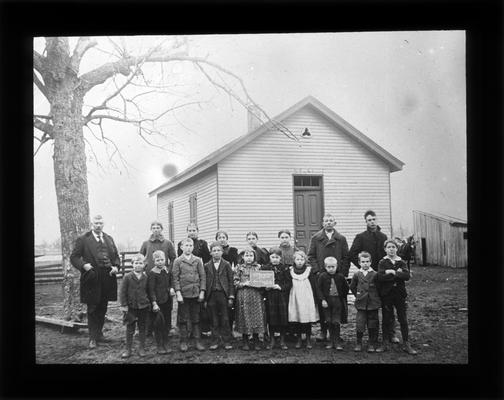 Students outside Cave Spring School, on Newtown Pike, with Miss Mary Kelley, teacher
