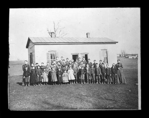 Students outside Athens School with Mrs. Mollie Stivers Barker and Miss Lizzie Bell Stivers, teachers